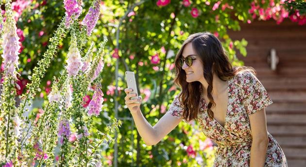 Frau mit Smartphone im Garten